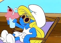 the smurf is sitting on a beach chair with an ice cream sundae