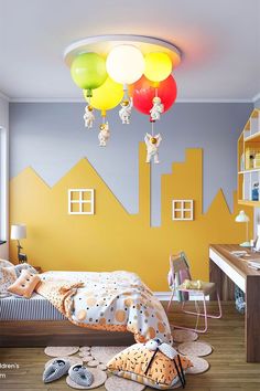 a child's bedroom decorated in yellow and blue with balloons hanging from the ceiling