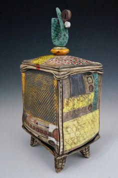 a decorative box with a bird on top