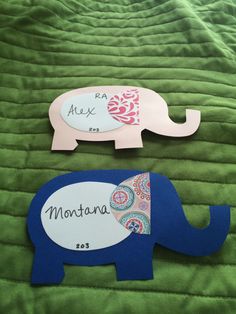 two pieces of paper cut out to look like elephants