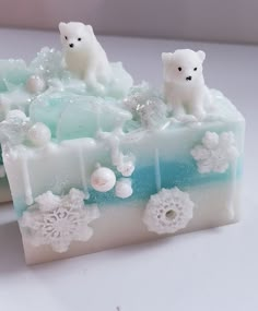 two soap bars decorated with snowflakes and polar bears sitting on top of each other