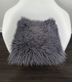 a white chair with grey fur on it