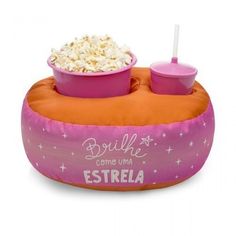 an inflatable float with two bowls of popcorn and a drink on the side