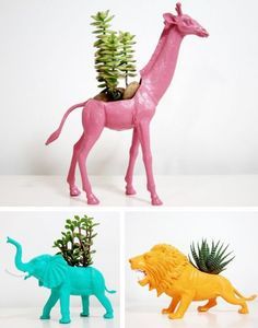 three different toy animals with plants in them