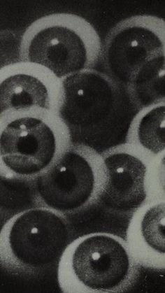 black and white photograph of many donuts with holes in the middle, all on one side