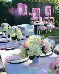 an instagram photo with pink and white flowers in vases on a table outside