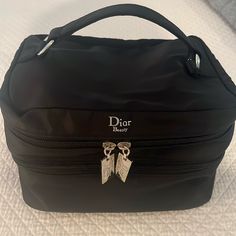 Dior Beauty Christian Dior Cosmetic Black Nylon Large 2-Tier Makeup And Toiletry Travel Bag Case. Spacious With Two Layers Of Compartments. Top Handle Has Silver Tone Hardware. Top Compartment Has Holders For Brushes & Etc. Bottom Compartment Is Large And Can Hold A Ton. Made Of Durable And Easy To Clean Nylon. Lightly Used With No Rips/Tears/Stains. Like New! Original Owner And From A Smoke-Free Home. 9 1/2” L X 7 1/4” W X 6” H Doir Makeup Bag, Dior Vanity Case, Dior Travel Nomad Pouch, Dior Travel Pouch, Black Cosmetic And Toiletry Storage For On-the-go, Dior Cosmetics, Tear Stains, Makeup Travel Case, Dior Beauty