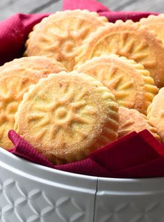 a white bowl filled with cookies on top of a table