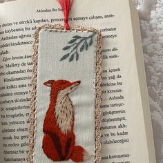 an embroidered bookmark with a red fox on it