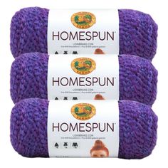 three skeins of yarn with the words homespun written on them in purple