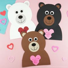 three bears with hearts cut out of them on a pink background, one bear is holding a heart