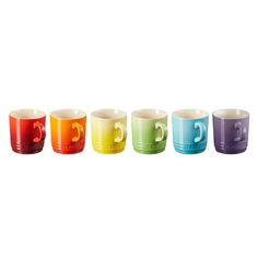 five different colored cups with numbers on them