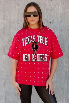 a woman wearing a red texas tech t - shirt and black leggings