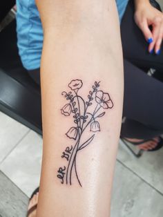 a woman's arm with flowers on it and the words, i love you in cursive writing