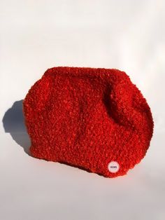 a red object sitting on top of a white surface