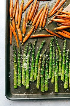 asparagus and carrots on a baking sheet