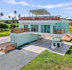 an aerial view of a two story house with balconies on the second floor