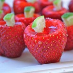 strawberries are arranged on a white tray