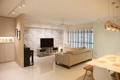 a living room filled with furniture and a flat screen tv on top of a wall