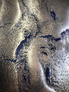 an aerial view of the water and land from space, looking down at it's surface