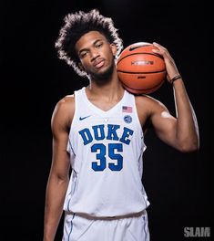 a man holding a basketball in his right hand