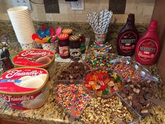 the ingredients for a candy bar are displayed on the counter top, including milk, cereals, and candies