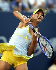 a woman swinging a tennis racquet at a ball