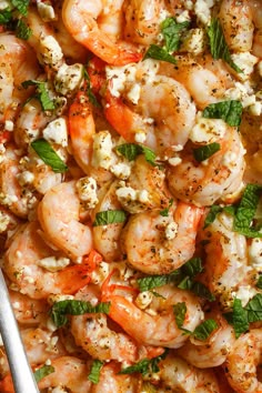 shrimp and feta salad in a bowl with a spoon on the side, ready to be eaten