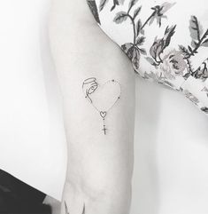 a woman's arm with a small tattoo on the left side of her arm