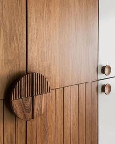 a close up of a wooden cabinet with knobs on the front and back doors