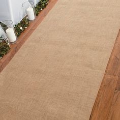 a large beige rug on the ground next to a white chair