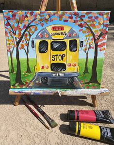 a yellow school bus painted on an easel