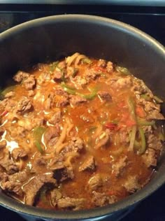 a pot filled with meat and vegetables on top of a stove