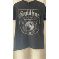 Get Ready To Rock Out In This Officially Licensed Sublime Bottled In Long Beach T-Shirt. Made With Ring Spun Cotton, This Shirt Is Perfect For All Seasons And Features A Solid Pattern With Short Sleeves And A Crew Neck. The Black Color And Sublime Graphic Print Make It A Must-Have For Any Music Lover. This T-Shirt Is Available In Size L And Is Machine Washable For Easy Care. The Shirt Is Preshrunk And Has A Regular Fit, Making It Comfortable And Stylish For Any Occasion. Tultex Is The Brand Behi Beach T Shirts, High Quality T Shirts, Long Beach, Short Sleeves, Tee Shirts, Mens Shirts, Man Shop, Brand New, T Shirt