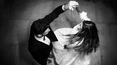 a man and woman are dancing together in black and white