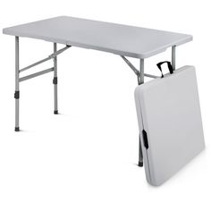 a white folding table with an umbrella on it