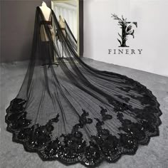 a black wedding veil on display in front of a mirror