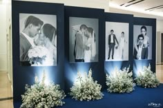 four black and white photos are on display in front of blue carpeted flooring