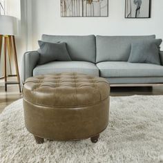 a living room scene with focus on the couch and ottoman