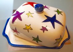 a cake with stars painted on it is sitting on a blue and white platter