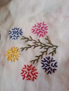 an embroidered cloth with colorful snowflakes on it