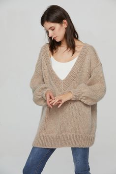 "Beautiful elegant mohair sweater is hand knitted of premium fluffy Angola mohair yarn that is soft, so light and warm. The long mohair sweater is perfect for smart and casual everyday outfit. Wear it with skinny, jeans or skirt. This sweater features: * oversized looking with extended length - cover your hip * 60% angola kid Mohair/ 20% wool/ 20% Nylon blended yarn * Deep V-neck Color: Pls. see color chart for color options and leave the note about the color when you place the order. SIZE: S/M: Woman Sweater, Mohair Yarn, Sweater Oversized, Sweater Oversize, Oversize Women, Light Knit, Mohair Sweater, Everyday Outfit, Pullover Sweater Women