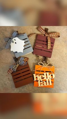 three wooden boxes with bows tied around them and the words hello fall written on them