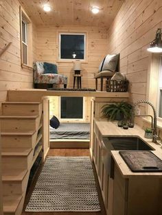 a tiny house with stairs leading up to the kitchen