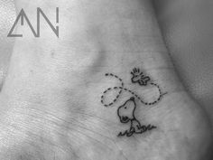 a small foot with a cartoon dog on it's side and the word love written in