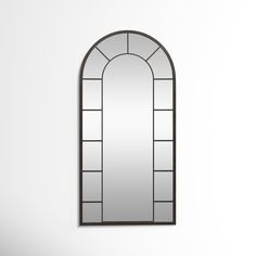 an arched mirror hanging on the wall