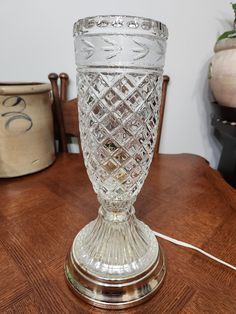 a glass vase sitting on top of a wooden table