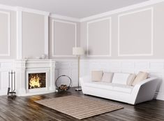 a living room with white furniture and wood flooring, along with a fire place