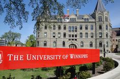 the university of winchester sign in front of a large building