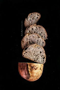 three pieces of bread sitting on top of each other in front of a black background